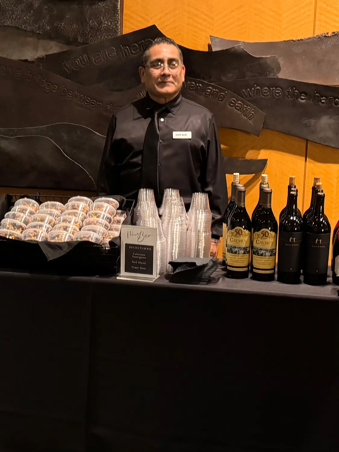 Man at table bar serving for event at The Canon Center